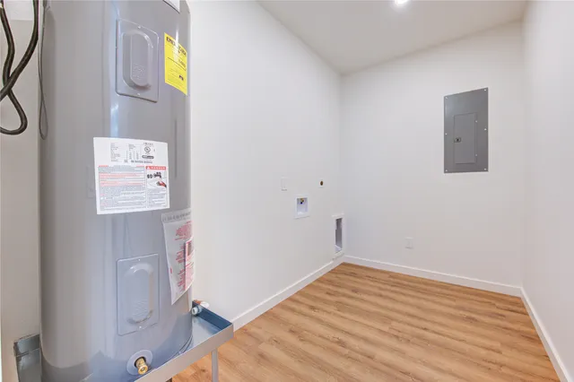 a view of a hallway with wooden floor and entryway
