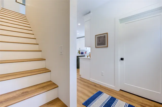 a view of entryway and hall with wooden floor