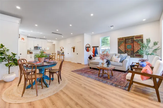a living room with fireplace furniture and a rug