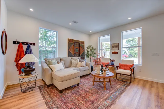 a living room with furniture and wooden floor