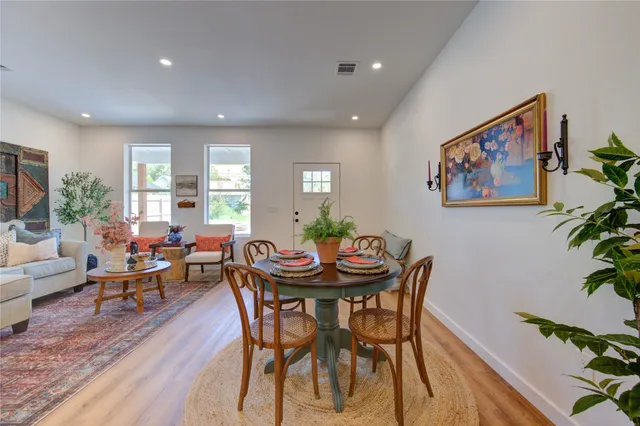 a view of a dining room with furniture and front door