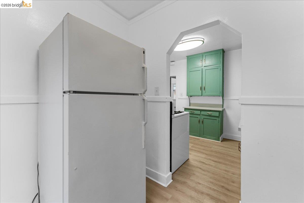 1127 Key Rte Boulevard Albany, CA 94706 - Photo 21 of 36 a view of hallway with cabinets and wooden floor