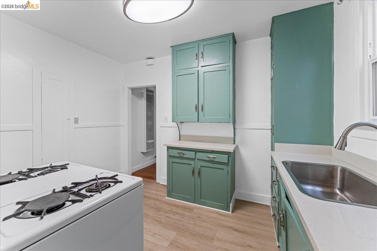 1127 Key Rte Boulevard Albany, CA 94706 - Photo 22 of 36 a kitchen with a sink stove and refrigerator