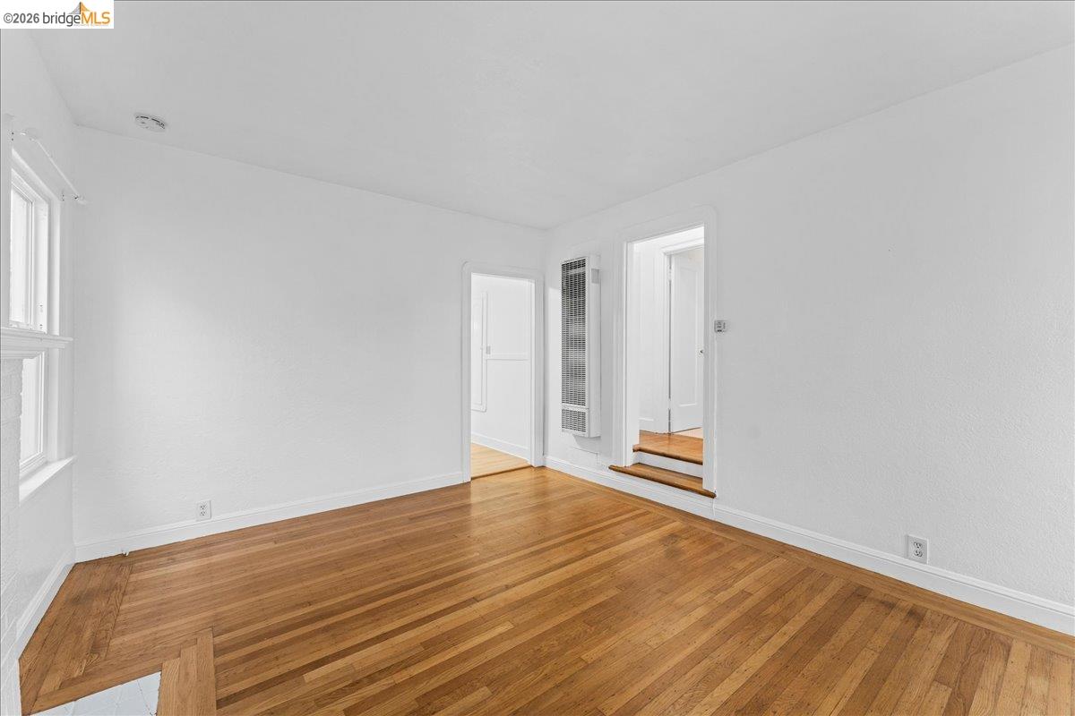 1127 Key Rte Boulevard Albany, CA 94706 - Photo 29 of 36 a view of an empty room with wooden floor and a window