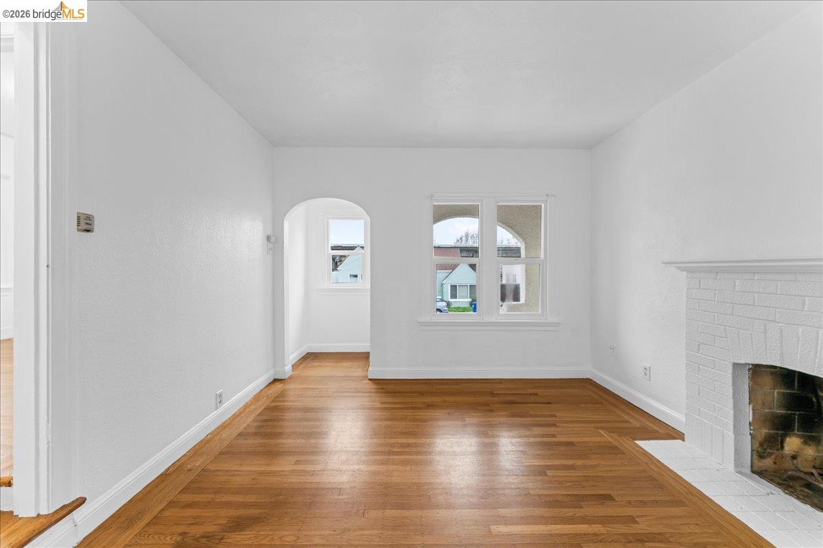 1127 Key Rte Boulevard Albany, CA 94706 - Photo 31 of 36 a view of empty room with window and wooden floor