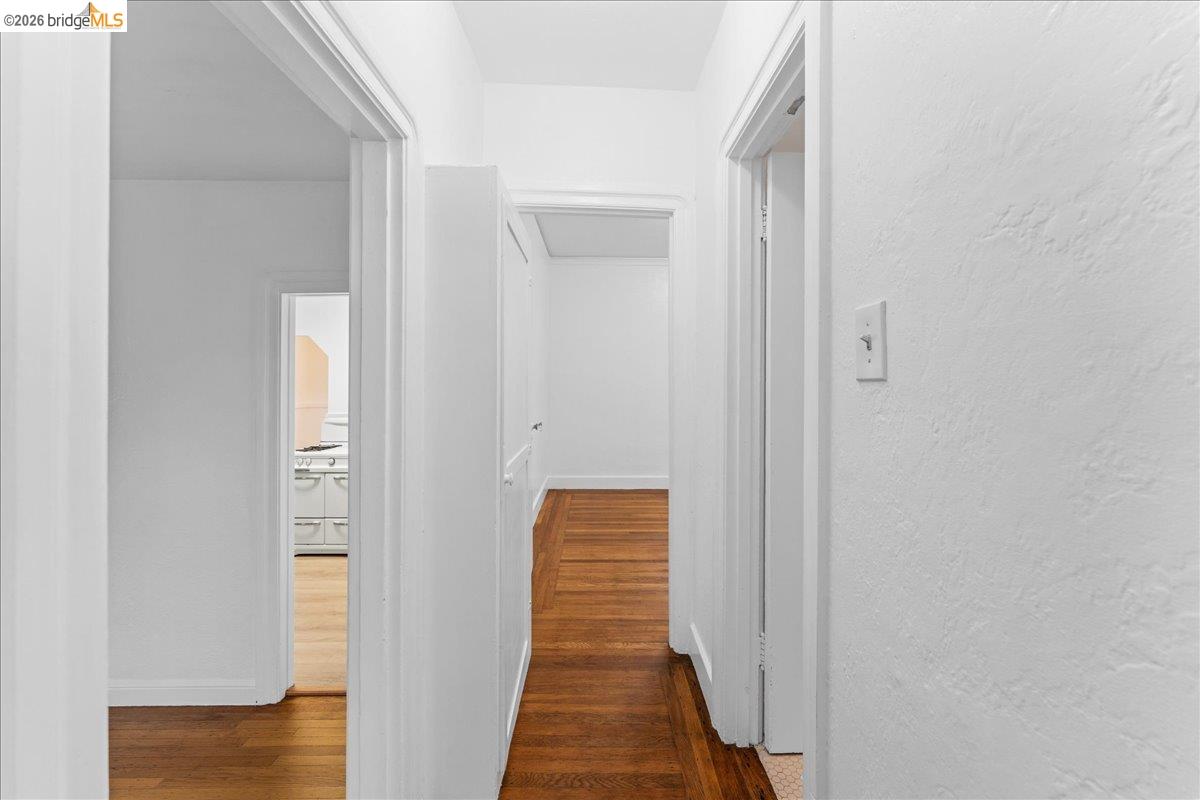 1127 Key Rte Boulevard Albany, CA 94706 - Photo 4 of 36 Corridor with dark wood-style floors and baseboards