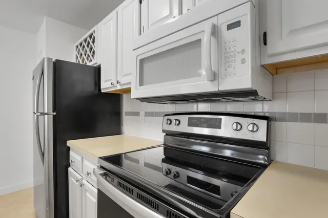 a stove top oven sitting inside of a kitchen