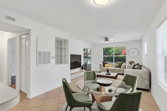 a dining room with furniture a window and kitchen view
