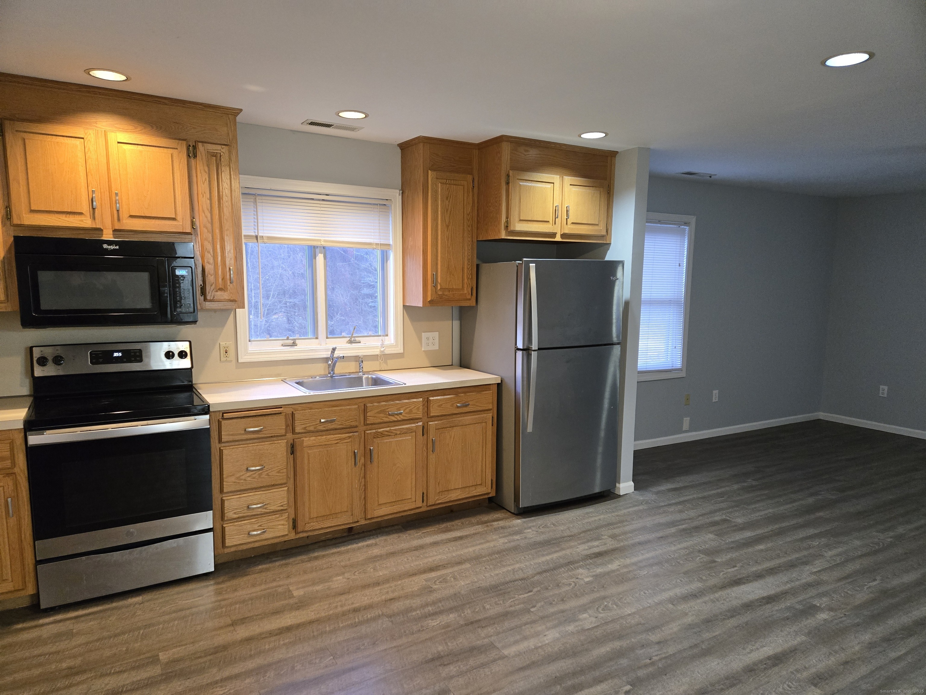 329 Mohegan Road, Unit A Shelton, CT 06484 - Photo 1 of 12 a kitchen with a refrigerator and a stove top oven