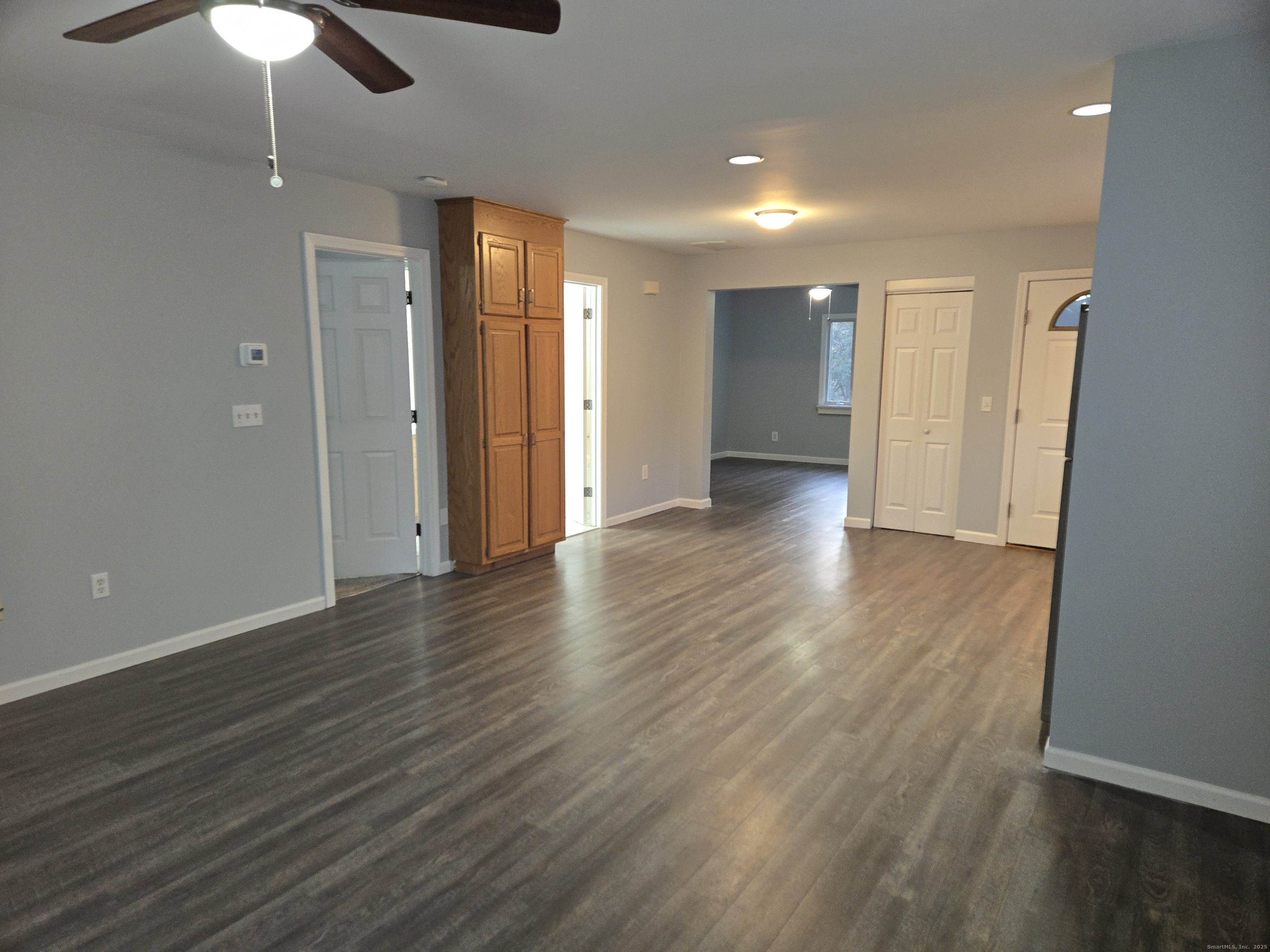 329 Mohegan Road, Unit A Shelton, CT 06484 - Photo 3 of 12 an empty room with wooden floor ceiling fan and window