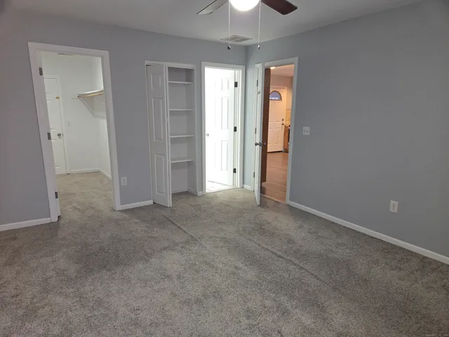 an empty room with closet and entryway