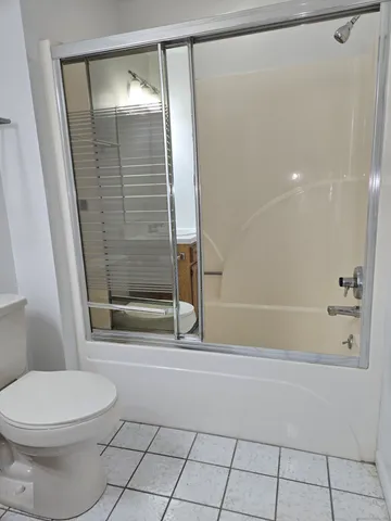 a bathroom with a toilet and a shower