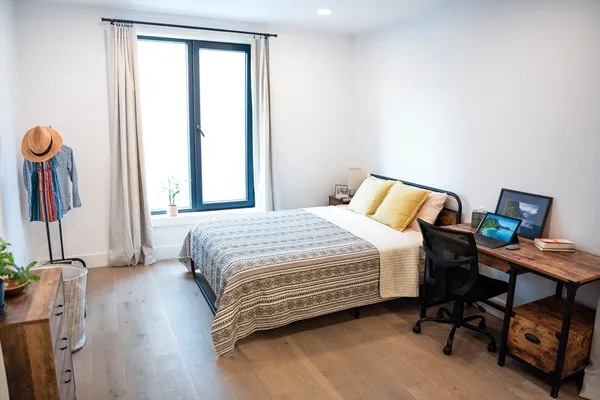 a bedroom with a bed and a window