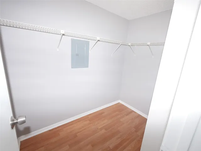 a view of a room with wooden floor