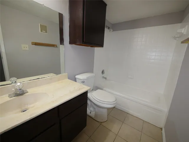 a bathroom with a sink a toilet and bathtub