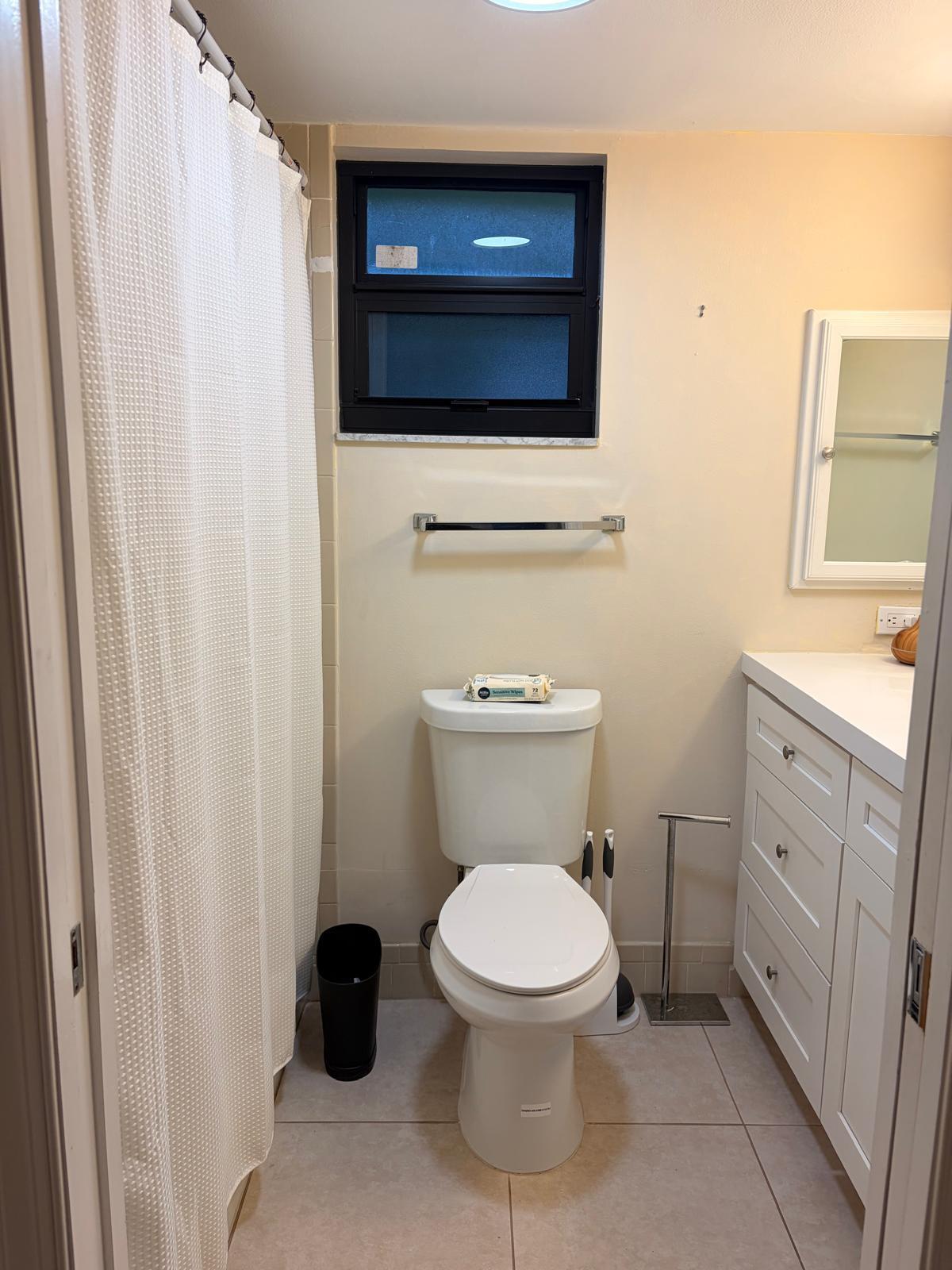 13334 Polo Club Road, Unit 216 Wellington, FL 33414 - Photo 5 of 9 a white toilet sitting next to a bathroom sink