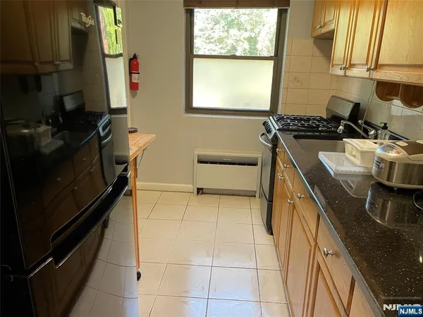 a kitchen with a sink a stove and a refrigerator