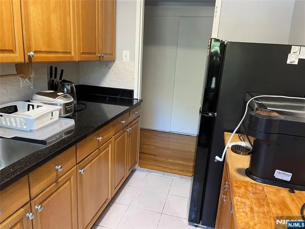 a kitchen with granite countertop a sink and a stove top oven