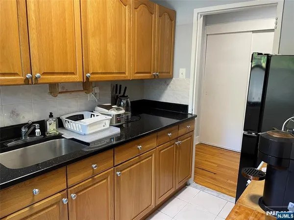a kitchen with stainless steel appliances granite countertop a sink a stove and a refrigerator