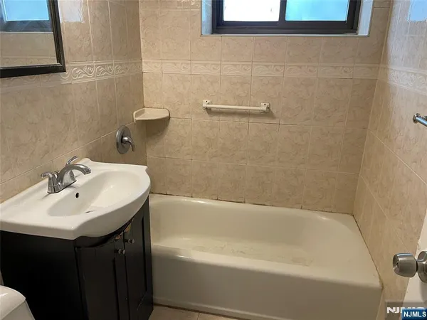 a white bath tub sitting next to a white sink