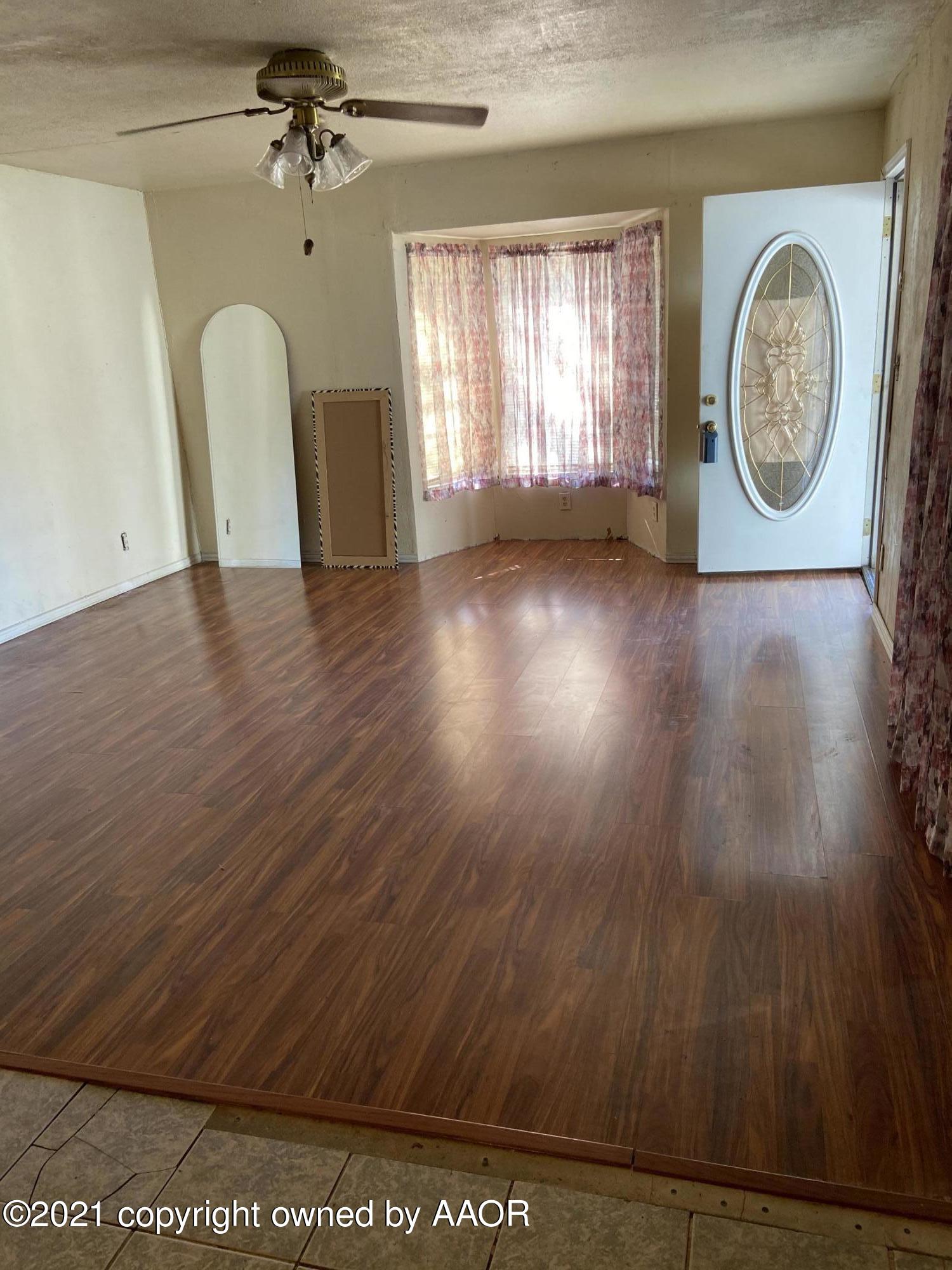 4339 South Tyler Street Amarillo, TX 79110 - Photo 2 of 11 a view of a room with wooden floor and window