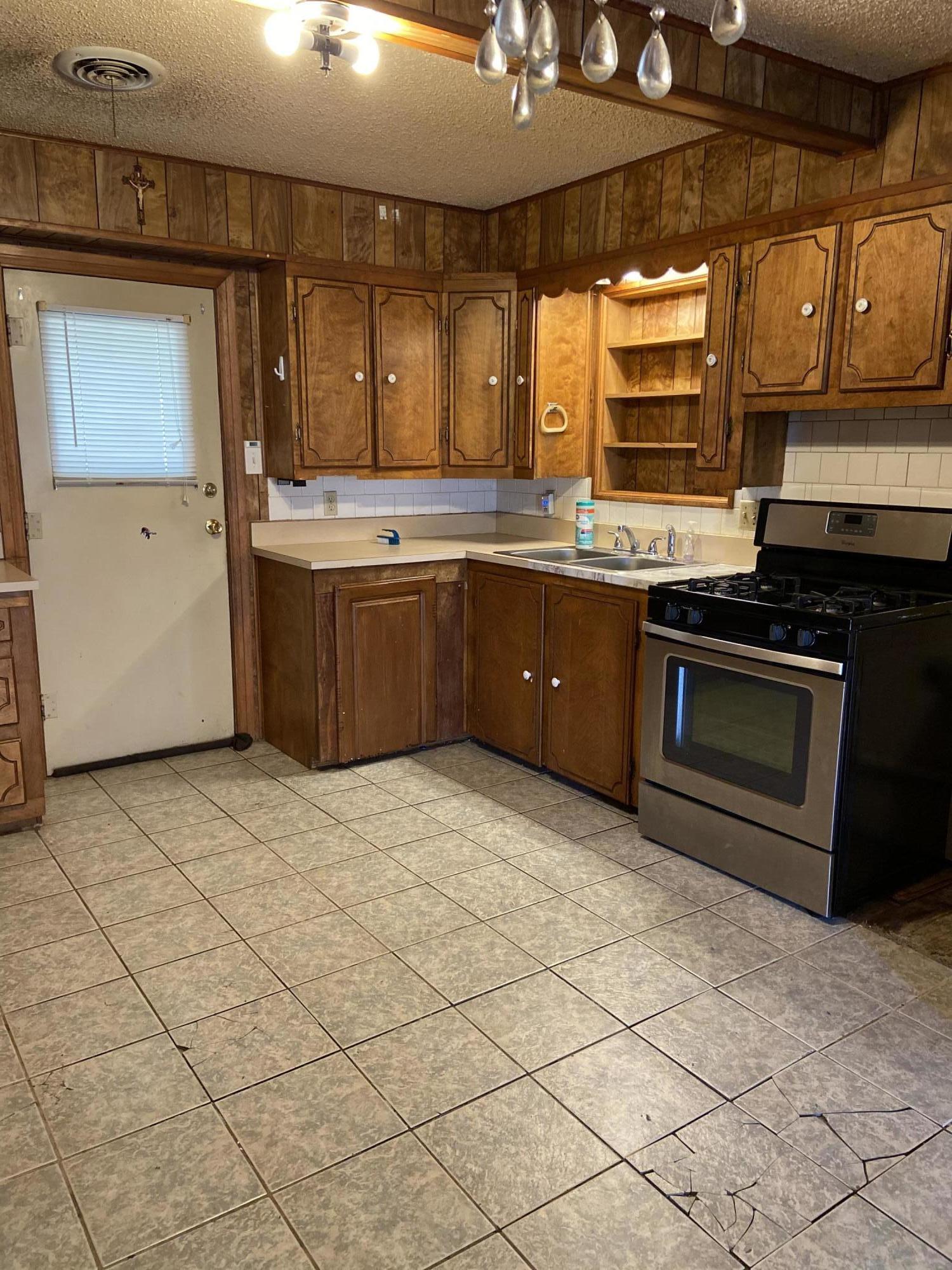 4339 South Tyler Street Amarillo, TX 79110 - Photo 4 of 11 a kitchen with stainless steel appliances granite countertop a stove a sink and a microwave