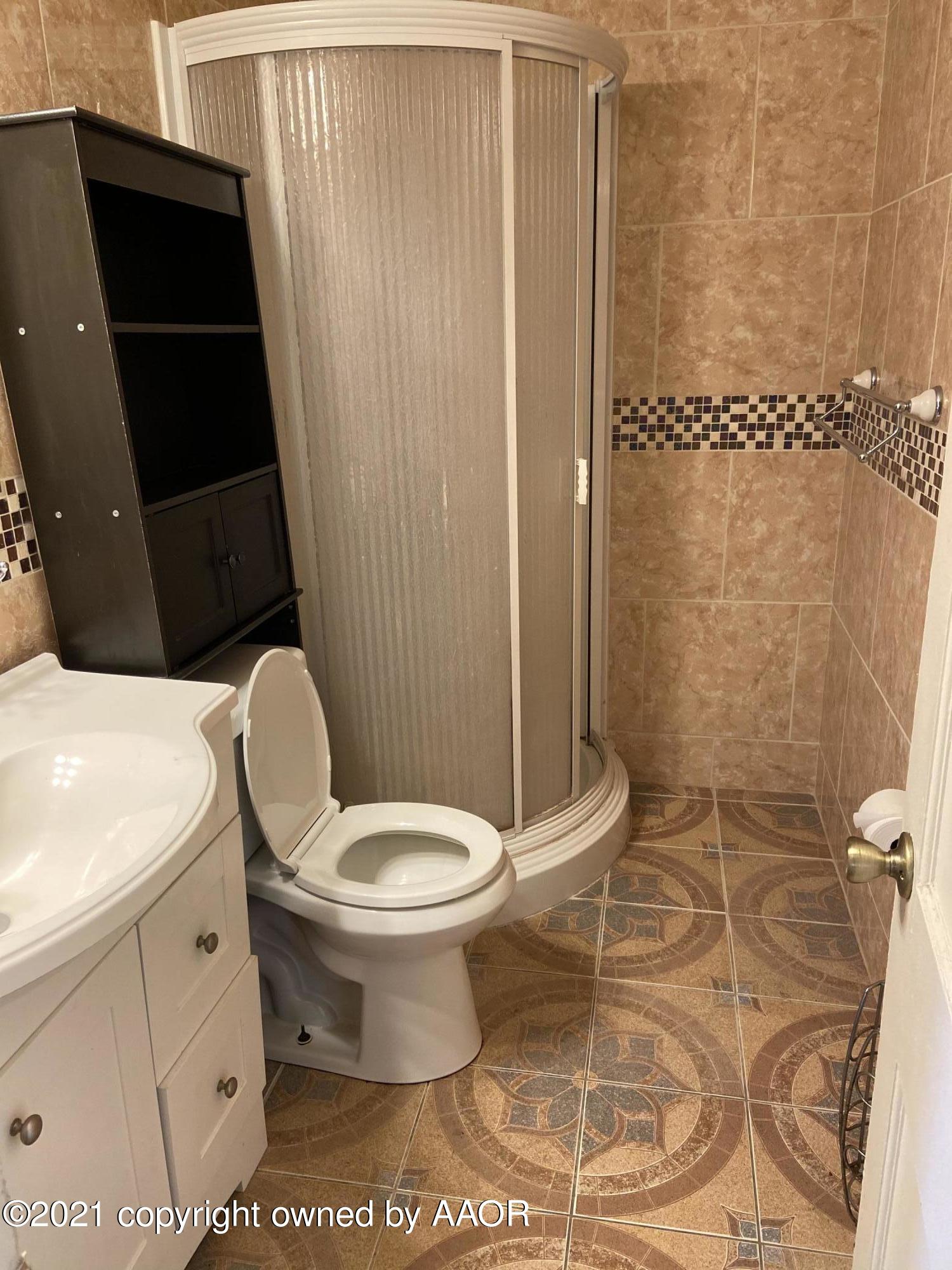 4339 South Tyler Street Amarillo, TX 79110 - Photo 6 of 11 a bathroom with a toilet and a shower