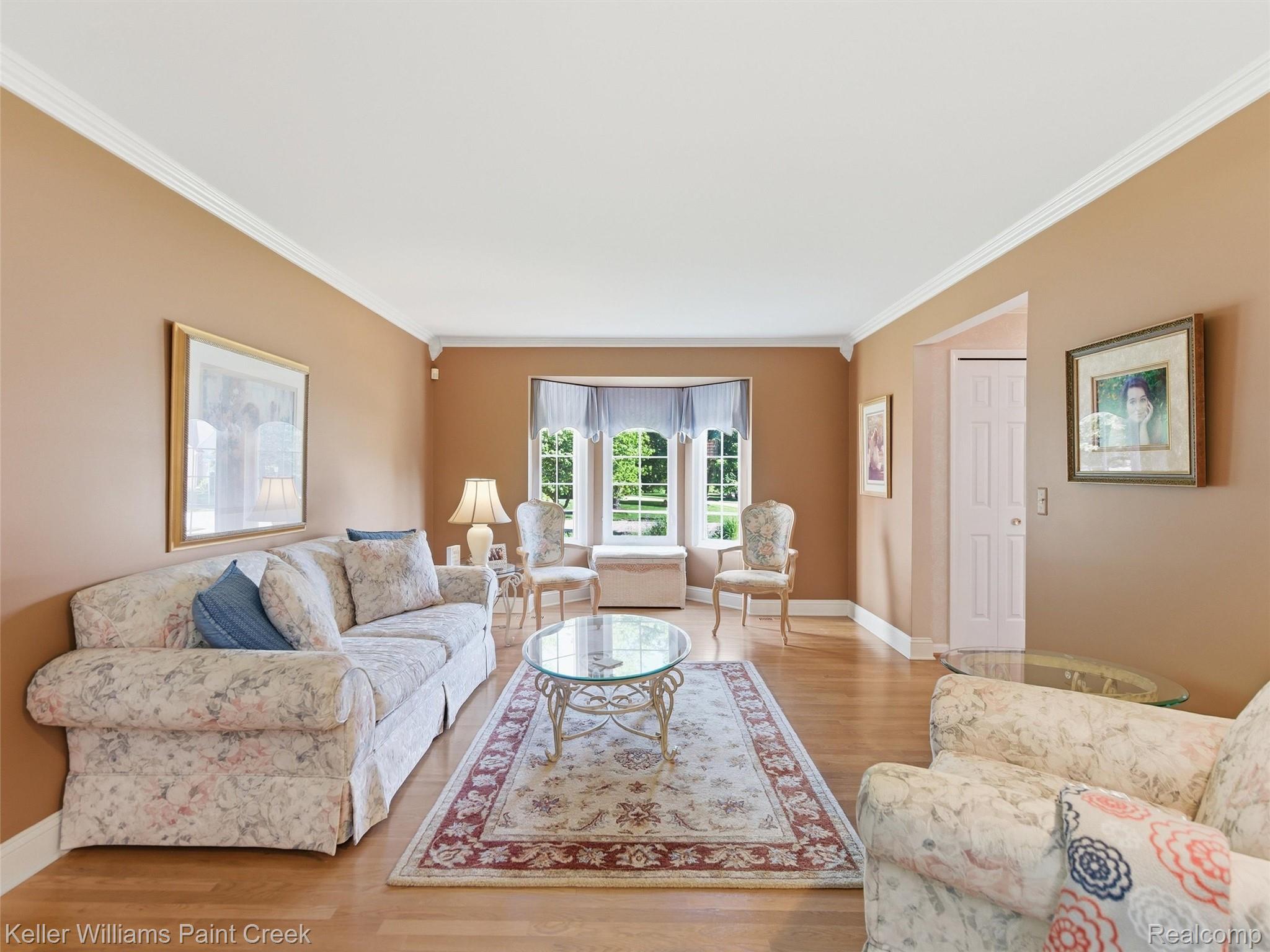 2842 Manorwood Road Troy, MI 48085 - Photo 24 of 72 Living area featuring a bay window, hardwood flooring, and crown molding