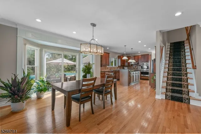 a dining room with furniture and wooden floor