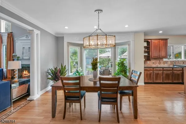 a dining room with furniture a chandelier and wooden floor
