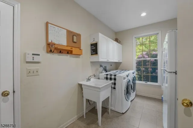 a white table chairs and a window in a room