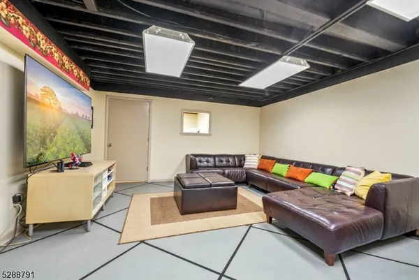a view of a dining room and livingroom with furniture wooden floor a chandelier