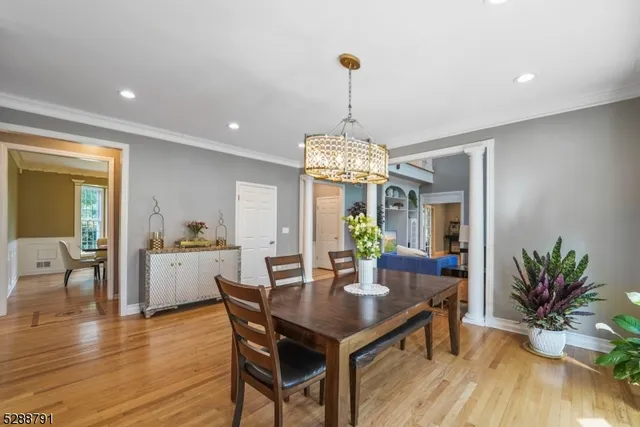 a kitchen with stainless steel appliances kitchen island granite countertop a stove a sink a refrigerator and a wooden cabinets