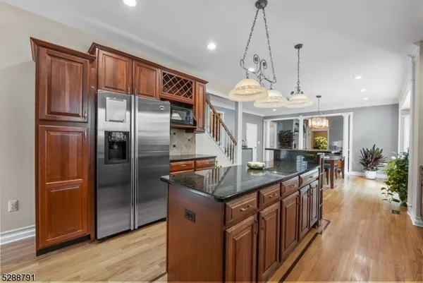 a kitchen with stainless steel appliances granite countertop a stove and a microwave