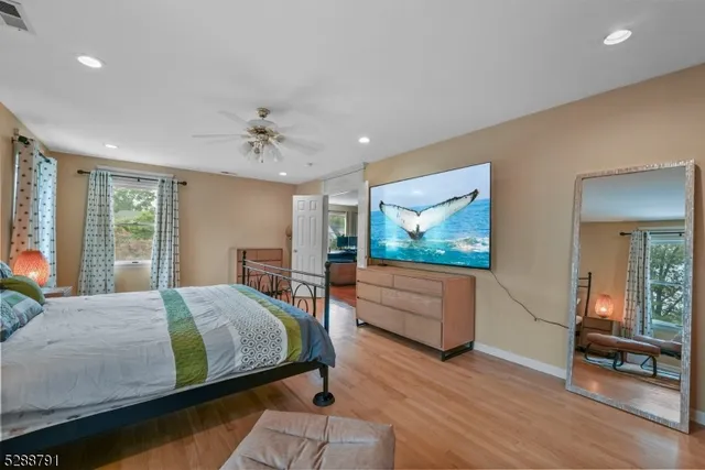 a view of a hallway to a livingroom with wooden floor