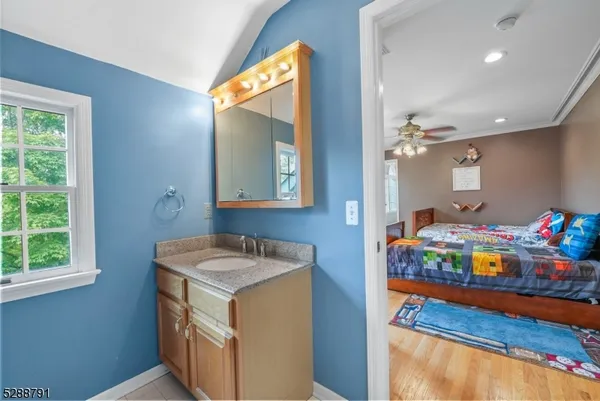 a bedroom with bed and a chandelier