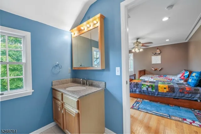 a bedroom with bed and a chandelier