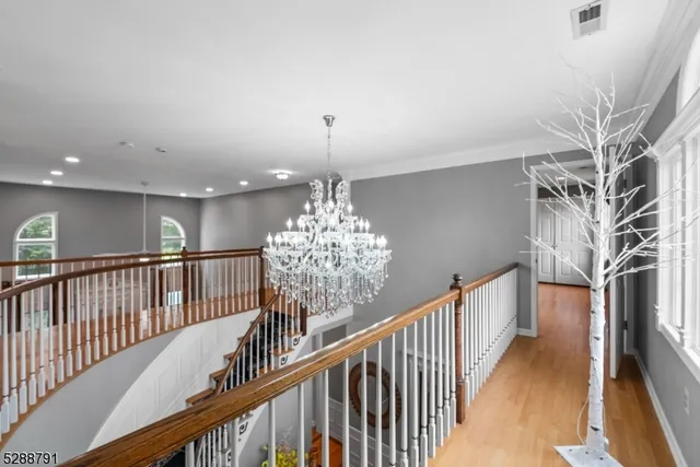 a spacious bedroom with a bed and a chandelier
