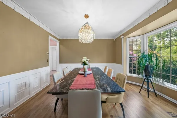 a very nice looking dining room with furniture window and wooden floor