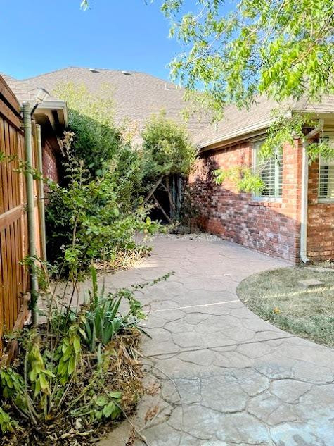3913 100th Street Lubbock, TX 79423 - Photo 22 of 35 a view of backyard with plants and outdoor seating