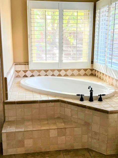 3913 100th Street Lubbock, TX 79423 - Photo 24 of 35 a bathroom with a tub and a sink