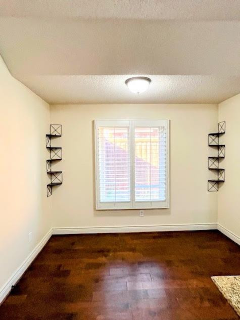 3913 100th Street Lubbock, TX 79423 - Photo 9 of 35 a view of an empty room with a window and wooden floor