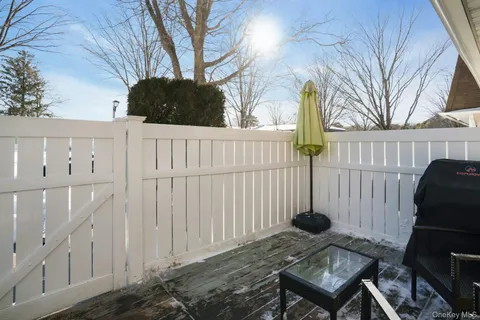 a view of a house with backyard and wooden fence
