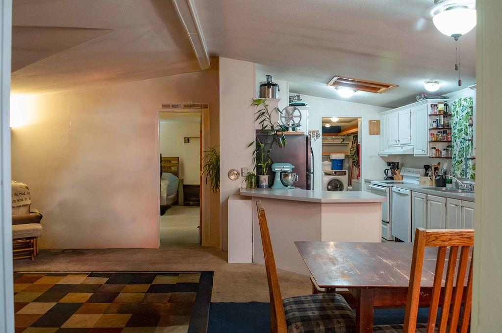 100 Ski Trails Road, Unit 40 Mammoth Lakes, CA 93546 - Photo 7 of 15 a kitchen with granite countertop dining table chairs and cabinets