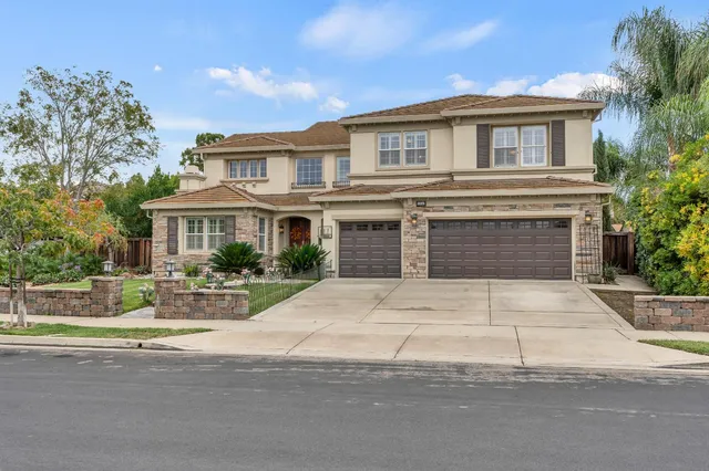 a front view of a house with a yard and a garage