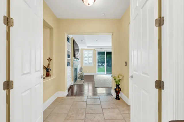 a living room with fireplace furniture and a floor to ceiling window