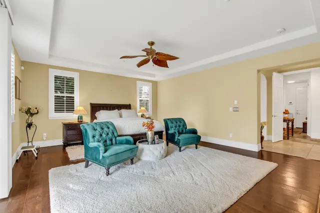a living room with fireplace furniture and a large window