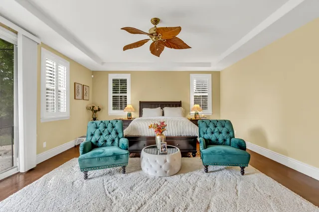 a living room with furniture kitchen view and a chandelier