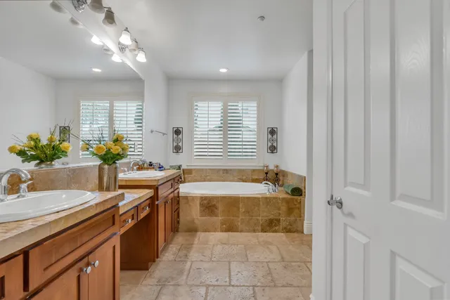 a kitchen with kitchen island granite countertop a sink stove and refrigerator