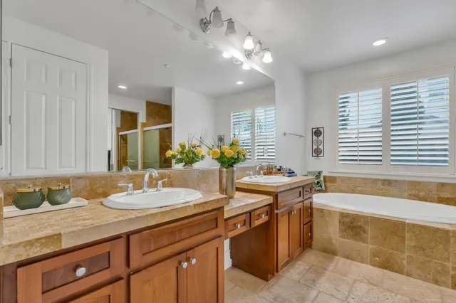 a kitchen with stainless steel appliances granite countertop a sink refrigerator and cabinets